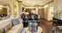Elegant living room with plush seating, stylish decor, and a modern open kitchen with bar seating.