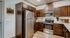 Modern kitchen with elegant dark wood cabinetry, stainless steel appliances, and sleek countertops, ideal for culinary creativity.