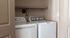 Modern laundry room with sleek washer and dryer tucked into a cozy alcove, offering efficient use of space.