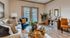Inviting living room with stylish decor, featuring a cozy sofa, chic armchair, and elegant glass coffee table.