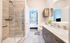 Contemporary bathroom design with spacious vanities and stand-up shower