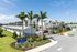 Contemporary active adult living community showcasing modern architecture, lush landscaping, and inviting palm trees.