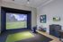Luxurious indoor golf simulator room with realistic course visuals and cozy seating, perfect for entertainment and practice.