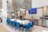 Modern kitchen with vibrant blue chairs, sleek island, and built-in appliances, ideal for stylish gatherings.