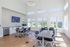 Bright and modern communal space with expansive windows, sleek furniture, and a large flat-screen TV, perfect for gatherings or study sessions.
