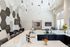 Modern, elegant communal space featuring high ceilings with stylish light fixtures, a sleek kitchen island, and contemporary decor perfect for entertaining.