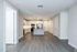 Modern open-concept kitchen with sleek appliances, elegant lighting, and spacious layout.