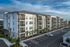 Modern apartment complex with clean architecture, lush landscaping, and ample parking, set against a vibrant blue sky.