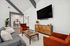 Elegant communal living space with vaulted ceilings, stylish seating, and a modern open-concept design.