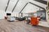 Modern lobby with sleek hardwood flooring, featuring stylish seating and comfortable seating, bathed in natural light.