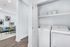 Modern laundry nook with a sleek white washer and dryer set, offering efficient space utilization.