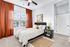 Bright and spacious bedroom with plush carpeting and large windows, perfect for natural light lovers.