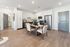 Modern open-concept kitchen with sleek stainless steel appliances, elegant white cabinetry, and a stylish dining area for seamless living.