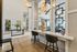 Luxurious apartment interior showcasing modern decor, elegant lighting, and stylish workstation with open spaces.