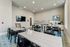 Chic communal space with modern tables, large TV, and stylish decor perfect for meetings and gatherings.