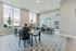 Bright communal space with large windows, featuring stylish seating and wall art, ideal for social gatherings and creative activities.