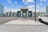 Inviting apartment complex entrance featuring modern design, surrounded by landscaped greenery and ample parking.