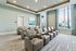 Modern home theater room featuring luxurious leather recliners, natural light, and stylish decor.