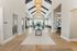 Luxurious and modern apartment lobby featuring high ceilings, elegant lighting, and stylish seating areas.