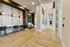 Contemporary lobby with elegant wood flooring, modern seating, and stylish pendant lighting, creating an inviting ambiance.