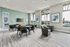 Bright and modern lounge area with elegant furnishings, large windows offering scenic views, and stylish decor, perfect for relaxation and gatherings.