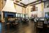 a large room with table and chairs and fire place to gather for events