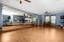a large room with a large studio mirror for excersize classes
