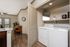 a living room with in-unit full-sized washer and dryer sets that are side by side