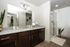 A large bathroom with spacious counter space and glass door showers