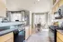 Bright modern kitchen with sleek appliances, granite countertops, and a cozy dining area by the window.