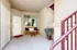 Inviting apartment entryway with a cozy wooden bench and decorative elements.