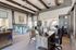 Elegant office lounge space featuring modern furniture, a desk setup, and a welcoming seating area with decorative accents.