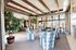 Luxurious lounge with patterned chairs, large windows, and modern decor.