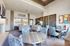 Bright and spacious clubroom area with elegant decor, featuring plush seating and a modern dining setup.