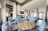 Stylish interior of a modern lounge with plush seating and a sleek metal dining table.