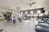 Bright and spacious gym with modern workout equipment, including treadmills and weight machines.