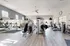 Bright, spacious fitness center with modern exercise equipment and large windows.