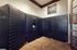 Secure package room with black Luxer One lockers and elegant tile flooring.