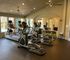 Spacious fitness center with state-of-the-art cardio equipment and poolside views.