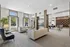 Elegant apartment lounge with modern seating, large windows, and a stylish design featuring a pool table and Library