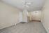 Inviting living area with plush carpet, modern ceiling fan and an open layout.