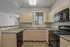 Modern kitchen with sleek appliances, light wood cabinetry, offering a stylish and functional cooking space.