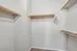 Spacious walk-in closet with ample shelving and hanging space, perfect for organizing your wardrobe.