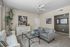 Charming living room with modern decor, featuring a plush sofa, stylish armchairs, and elegant art pieces, creating a welcoming and cozy ambiance.