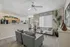 Bright open-concept living room with elegant decor, plush seating, and a view of a modern kitchen, creating a welcoming and stylish atmosphere.