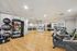 Elegant fitness studio with mirrored walls, exercise equipment, and vibrant gym accessories on hardwood floors.