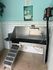 Chic pet washing station with modern stainless steel design, soothing blue walls, and playful art decor for a relaxing experience.