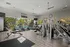Bright, modern fitness center equipped with state-of-the-art exercise machines overlooking a scenic outdoor view.