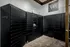 Modern parcel locker room with sleek black Luxer One lockers providing secure and convenient package storage.