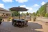 Chic outdoor patio with a modern dining set, large umbrella, and built-in BBQ grill, offering a perfect space for al fresco dining.